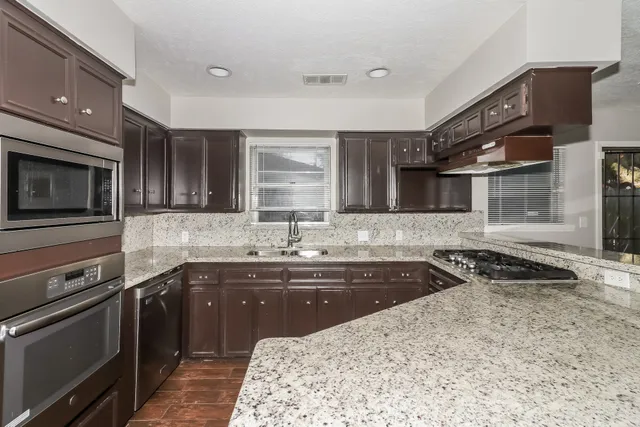 a kitchen with a sink stove and microwave