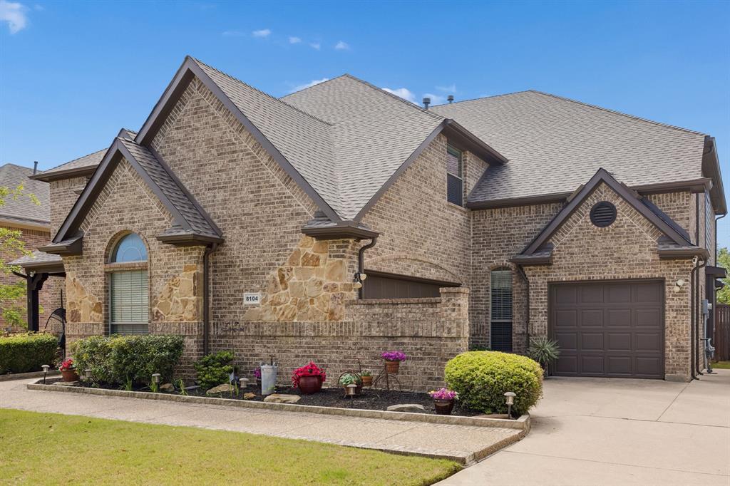 8104 Red Riv Run North Richland Hills, TX 76180 - Photo 2 of 38 a front view of a house with a yard and garage