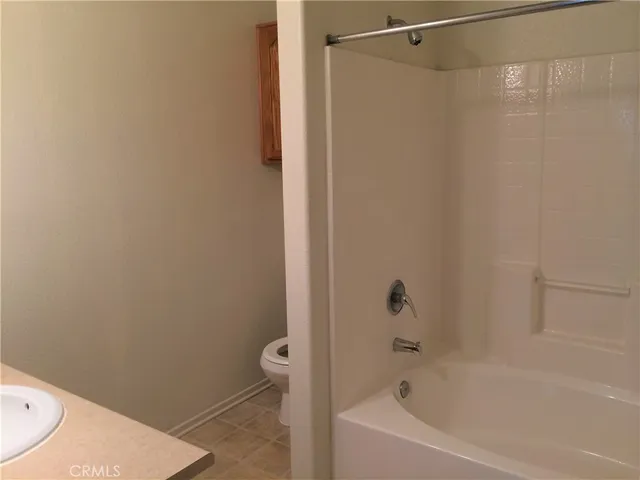 a bathroom with a bathtub and a toilet