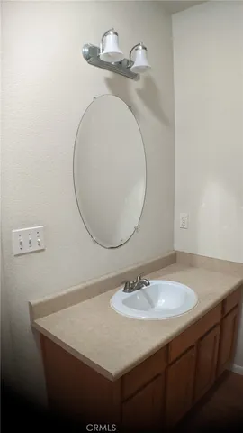 a bathroom with a sink a mirror and vanity