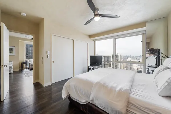 a bedroom with a bed and a large window