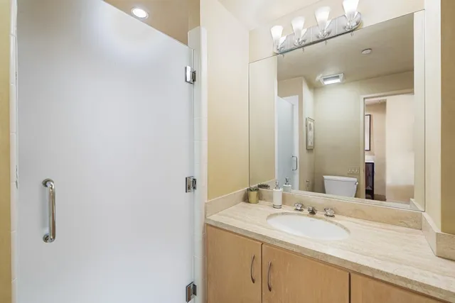 a bathroom with a granite countertop sink mirror and double
