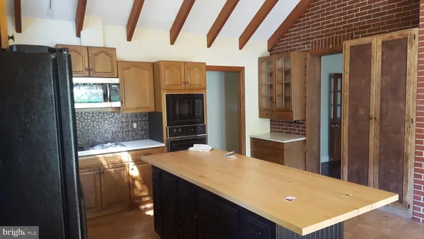 a kitchen with refrigerator and window