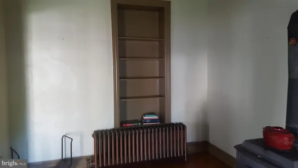 a view of a bedroom with wooden floor