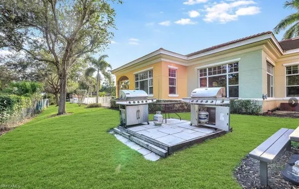 a view of a house with backyard porch and sitting area