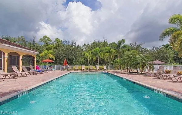 a swimming pool with outdoor seating and yard