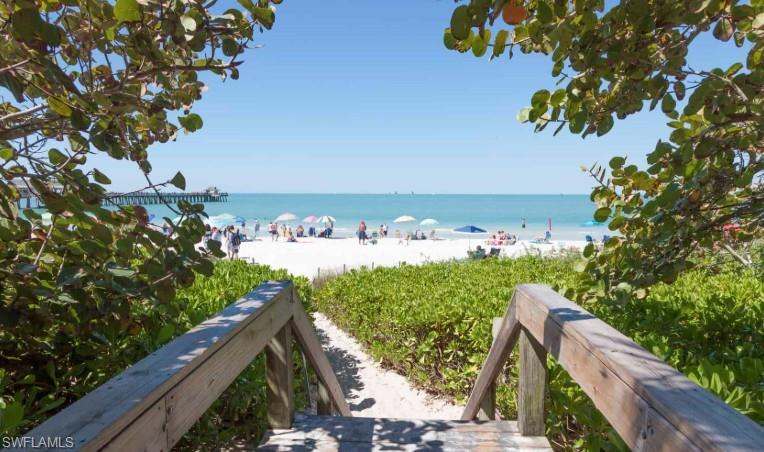 4430 Botanical Pl Circle, Unit 303 Naples, FL 34112 - Photo 22 of 22 a view of a house with a yard and potted plants