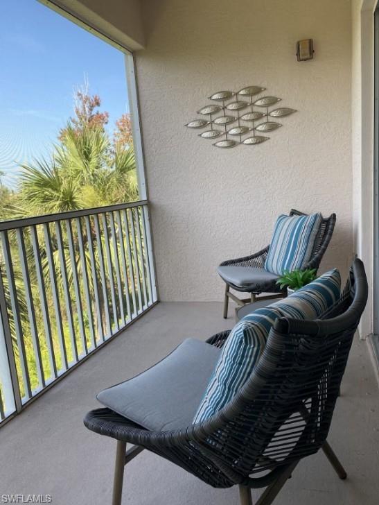 4430 Botanical Pl Circle, Unit 303 Naples, FL 34112 - Photo 8 of 22 a view of a balcony with furniture and a potted plant