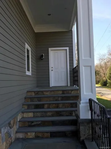 a view of a house with a wooden floor and a floor to ceiling window