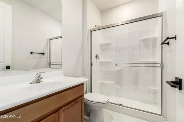 a living room with furniture kitchen area and a chandelier