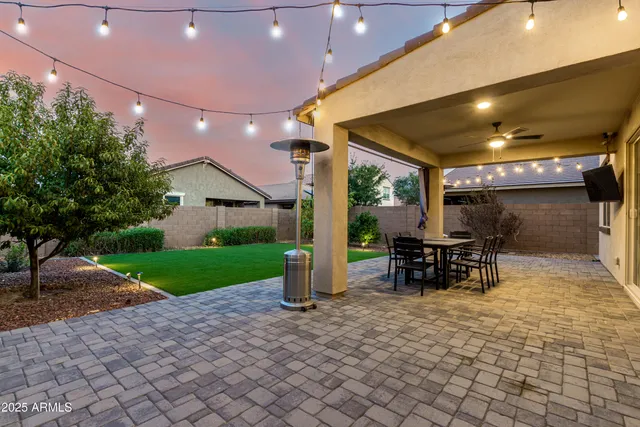a view of a patio with table and chairs