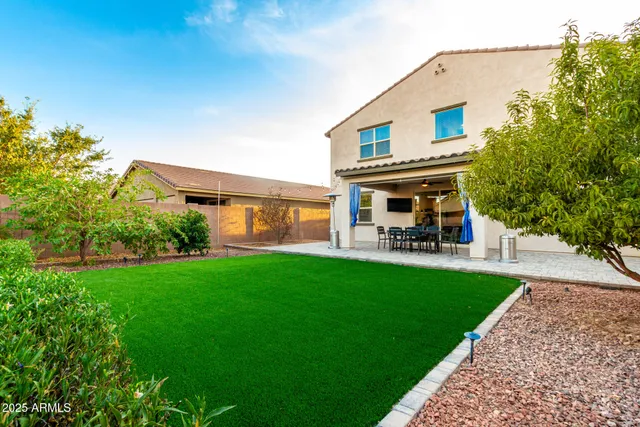 a view of a patio with table and chairs and potted plants