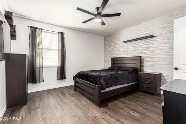 a bedroom with a bed and a flat tv screen