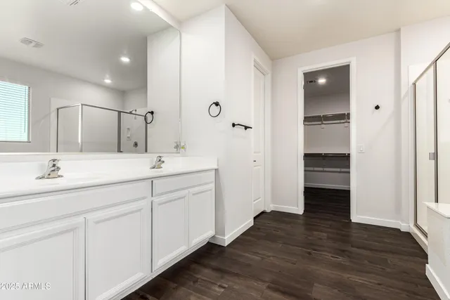 a bathroom with a double vanity sink and a mirror