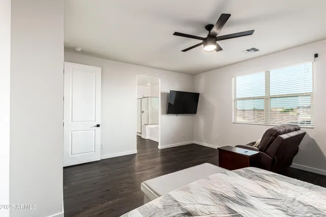 a bedroom with a bed and a flat screen tv