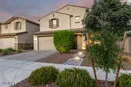 a view of a big house with a big yard and large trees