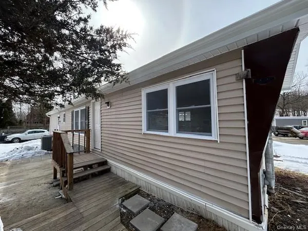 a view of a backyard with a chair and wooden floor