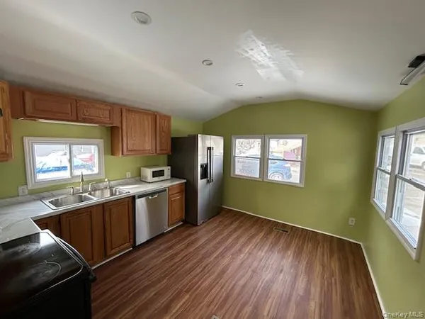 a view of a kitchen counter space wooden floor and windows