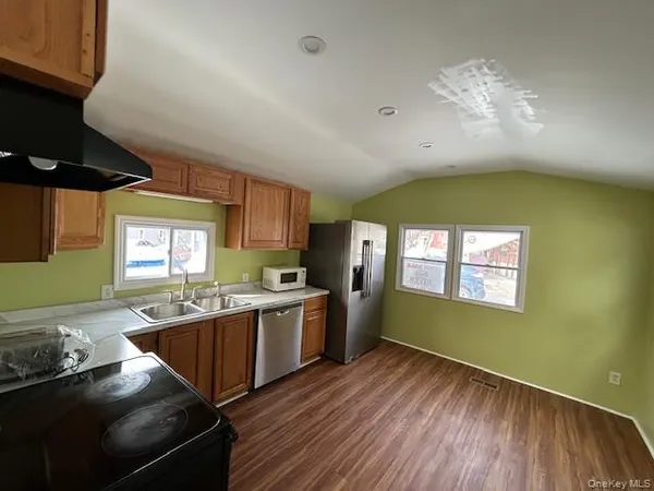 a kitchen with stainless steel appliances granite countertop a sink stove and cabinets