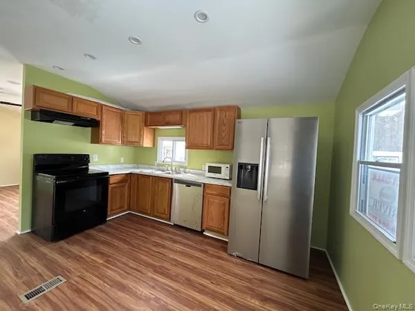 a kitchen with a refrigerator stove and sink