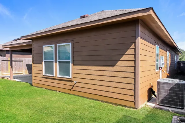 a side view of a house with a yard