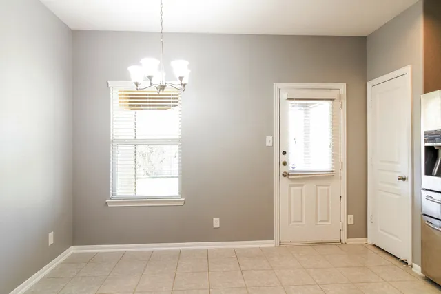a view of a kitchen with wooden floor and a window