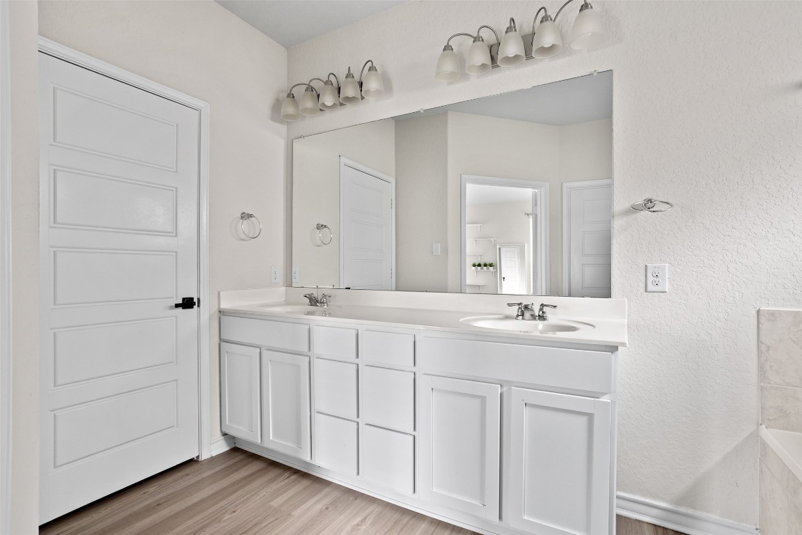 3409 Copper Acres Bulverde, TX 78163 - Photo 12 of 23 a bathroom with a double vanity sink and mirror