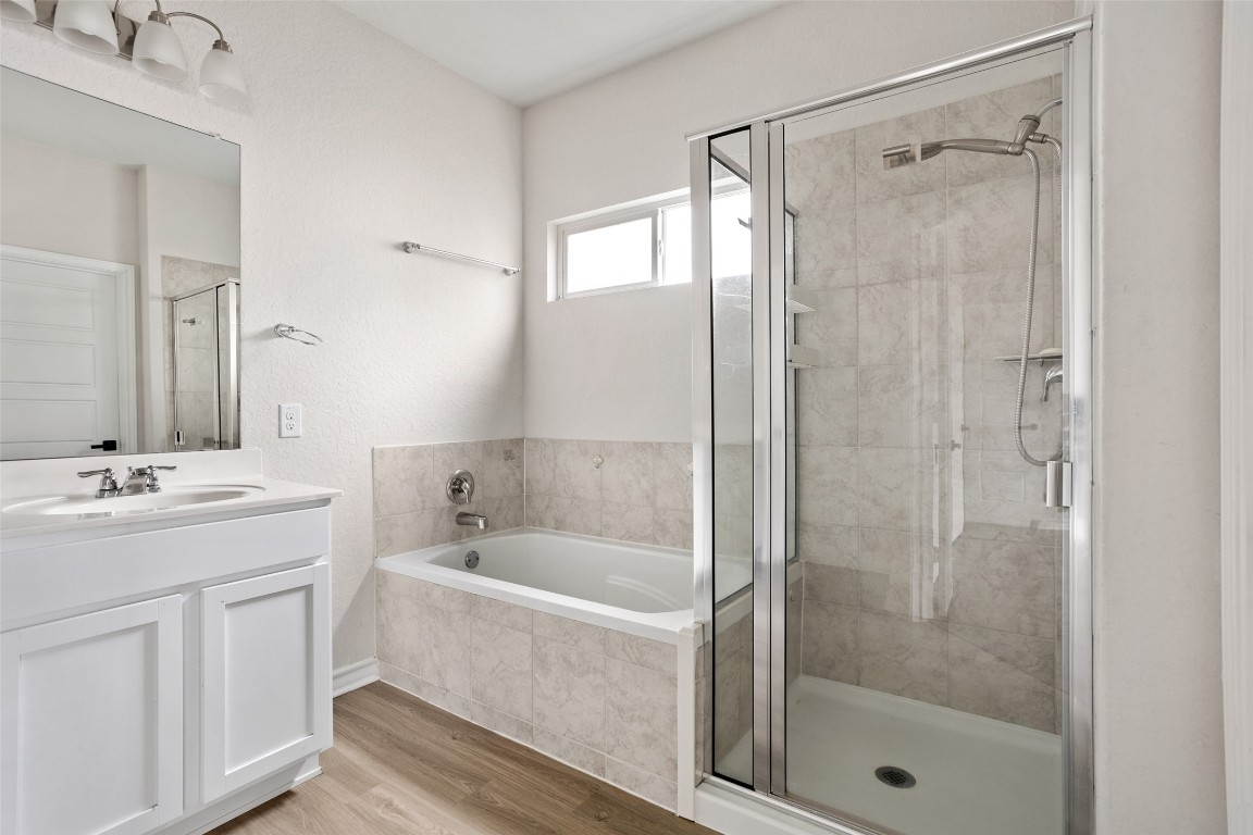 3409 Copper Acres Bulverde, TX 78163 - Photo 13 of 23 a bathroom with a bathtub shower sink vanity and toilet