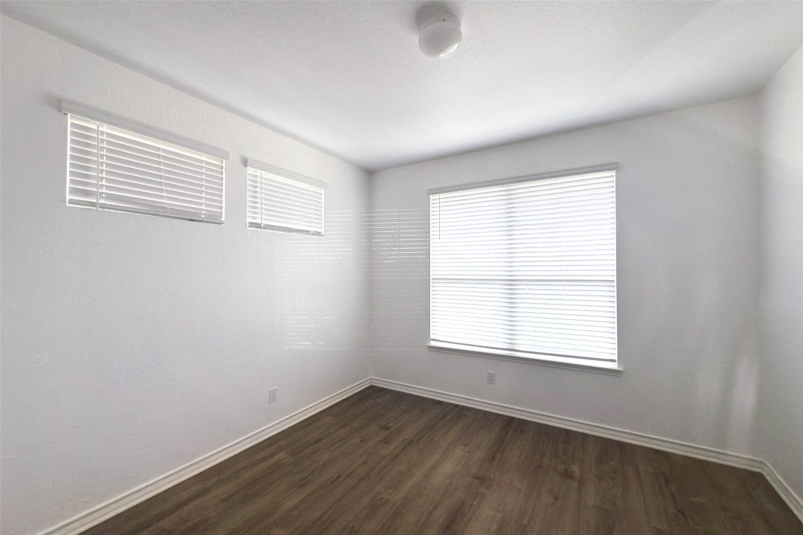 3409 Copper Acres Bulverde, TX 78163 - Photo 19 of 23 an empty room with wooden floor and windows
