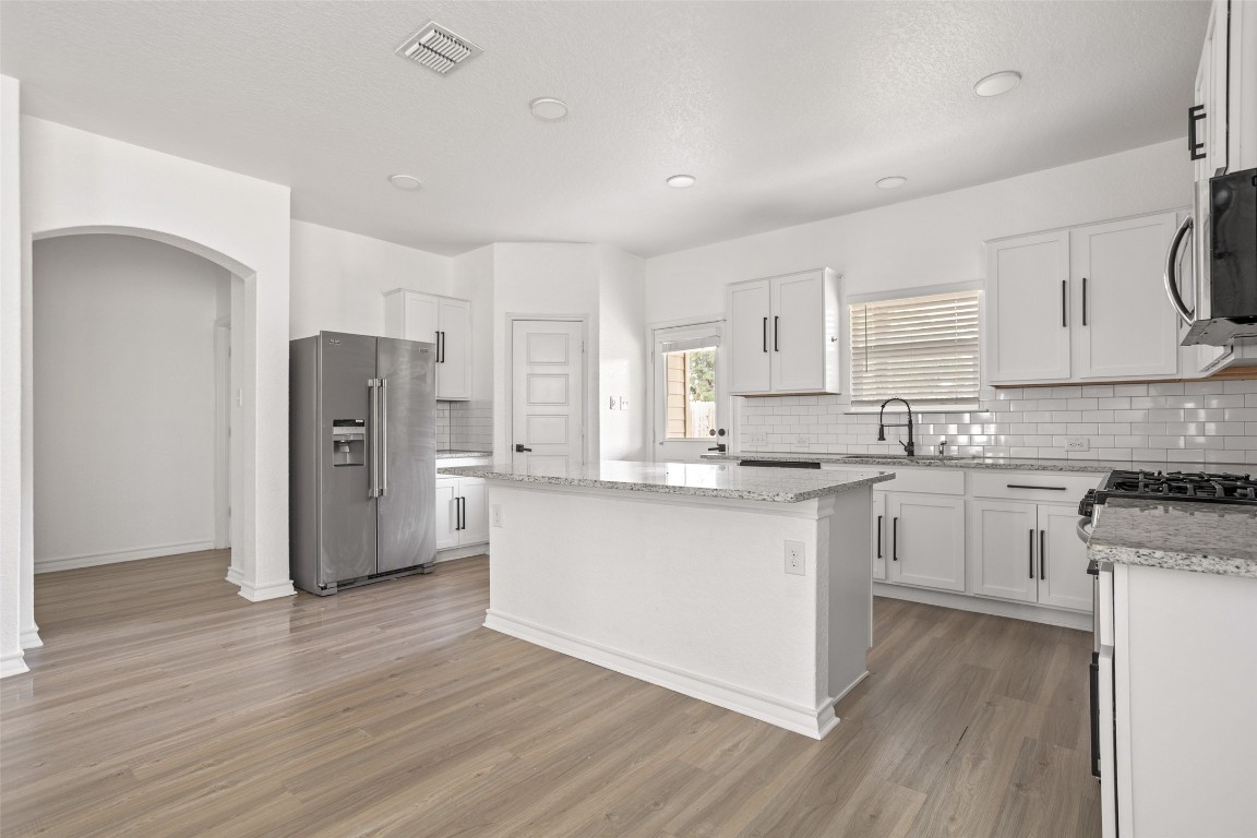 3409 Copper Acres Bulverde, TX 78163 - Photo 7 of 23 a kitchen with stainless steel appliances a refrigerator sink and cabinets