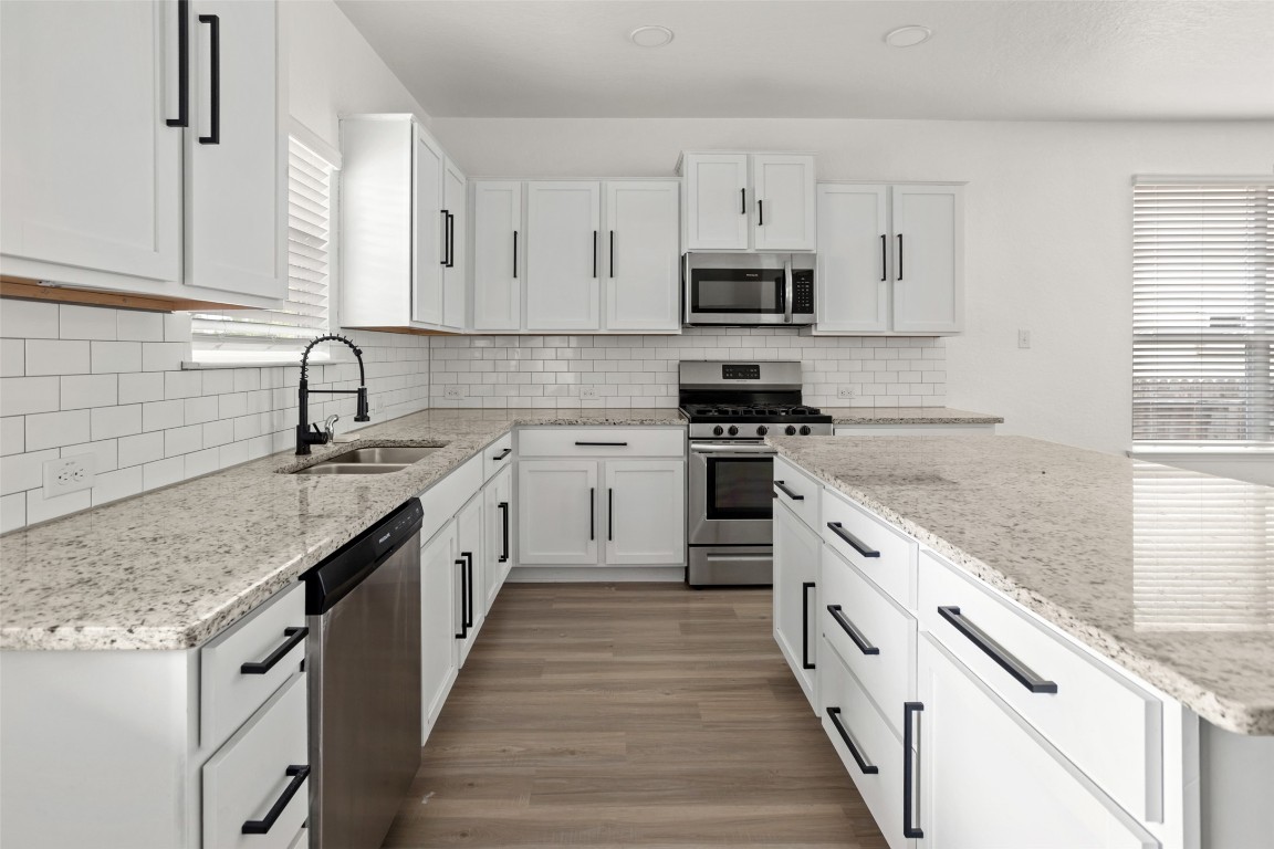 3409 Copper Acres Bulverde, TX 78163 - Photo 9 of 23 a kitchen with stainless steel appliances granite countertop a sink stove and cabinets