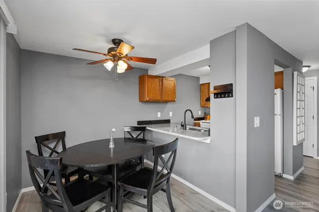 a kitchen with a sink a counter space and a view of living room