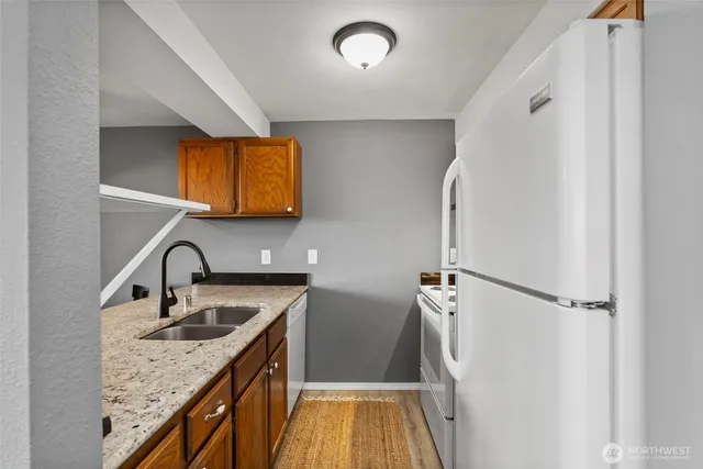 a kitchen with stainless steel appliances granite countertop a sink stove and refrigerator