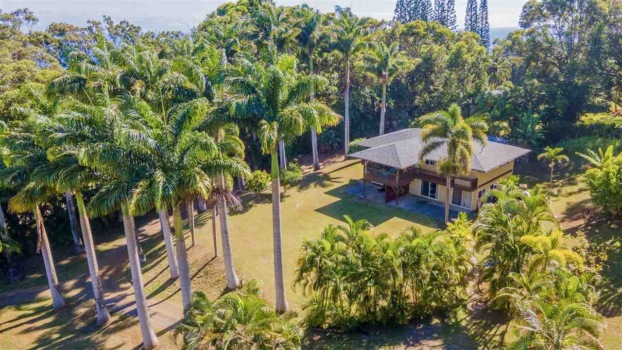 a backyard of a house with table and chairs