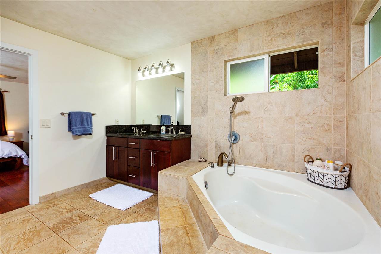 4509 Opana Place Haiku, HI 96708 - Photo 12 of 26 a bathroom with a tub sink and mirror