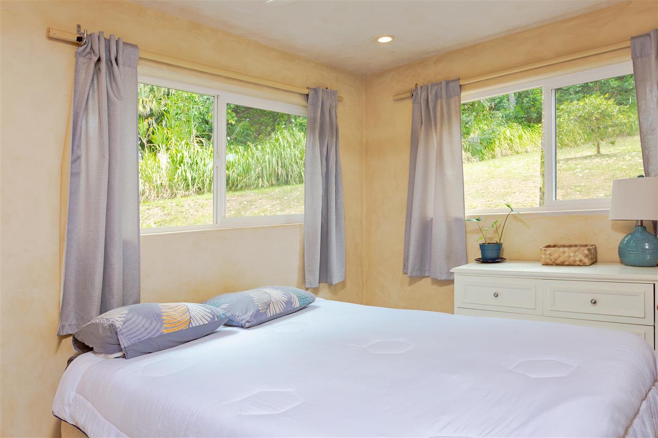 4509 Opana Place Haiku, HI 96708 - Photo 19 of 26 a bedroom with a bed and a window