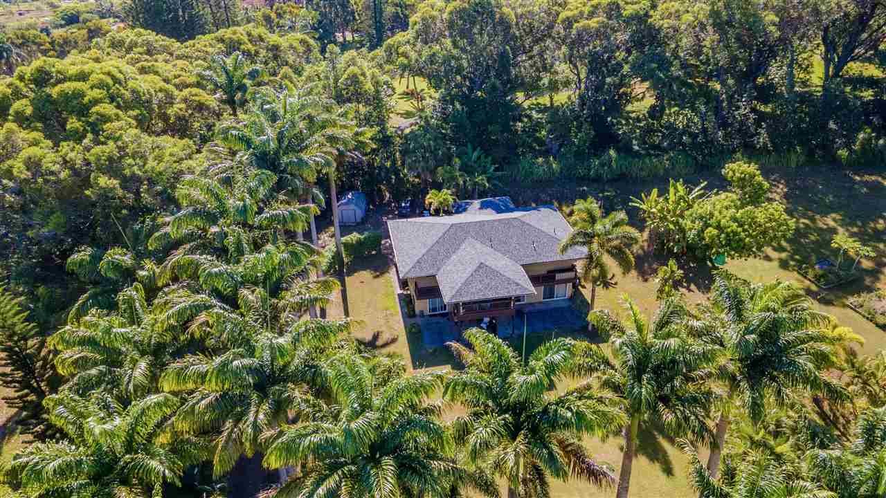 4509 Opana Place Haiku, HI 96708 - Photo 2 of 26 a view of a house with a yard and sitting area