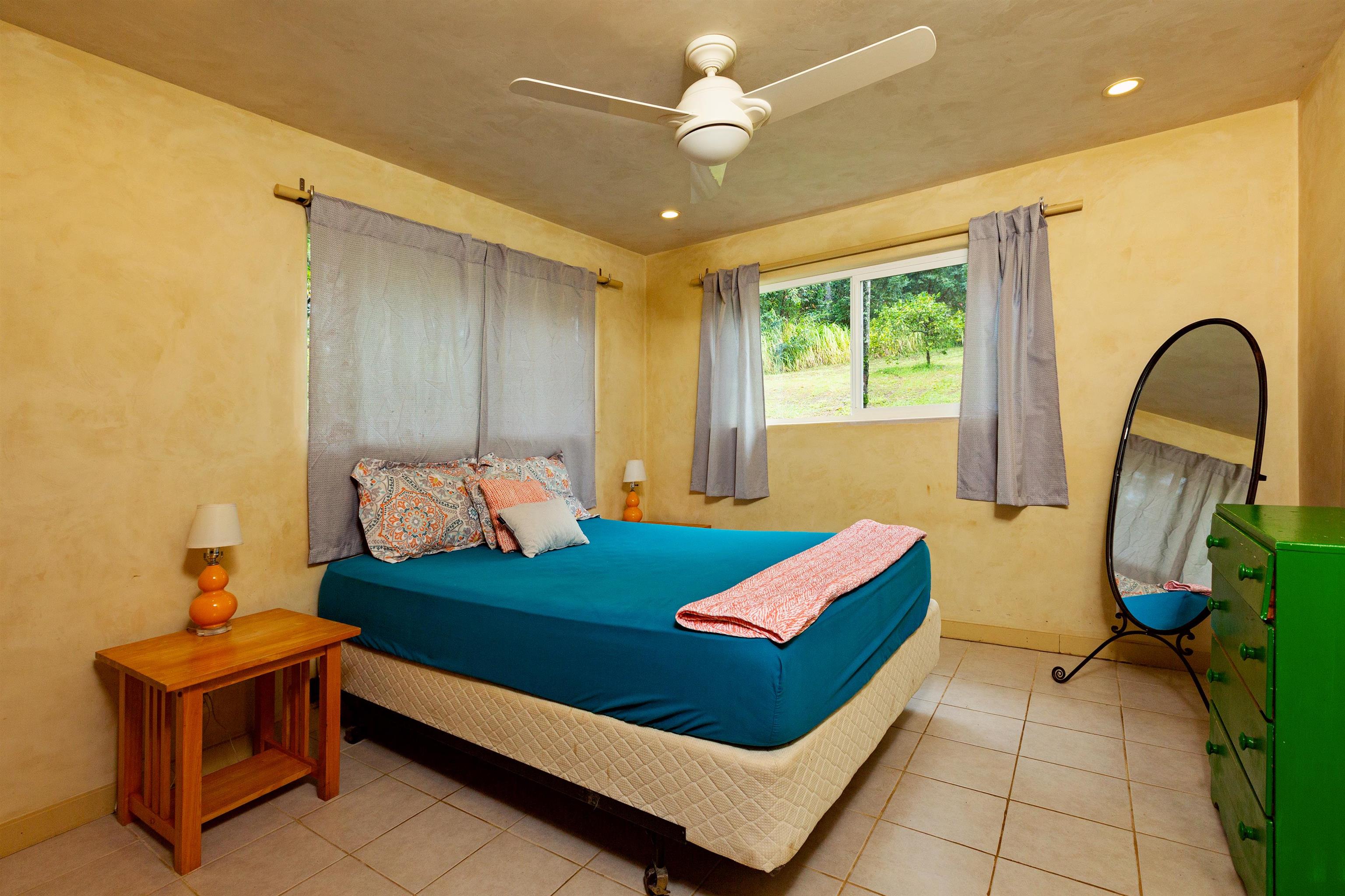 4509 Opana Place Haiku, HI 96708 - Photo 21 of 26 a bedroom with furniture and a window