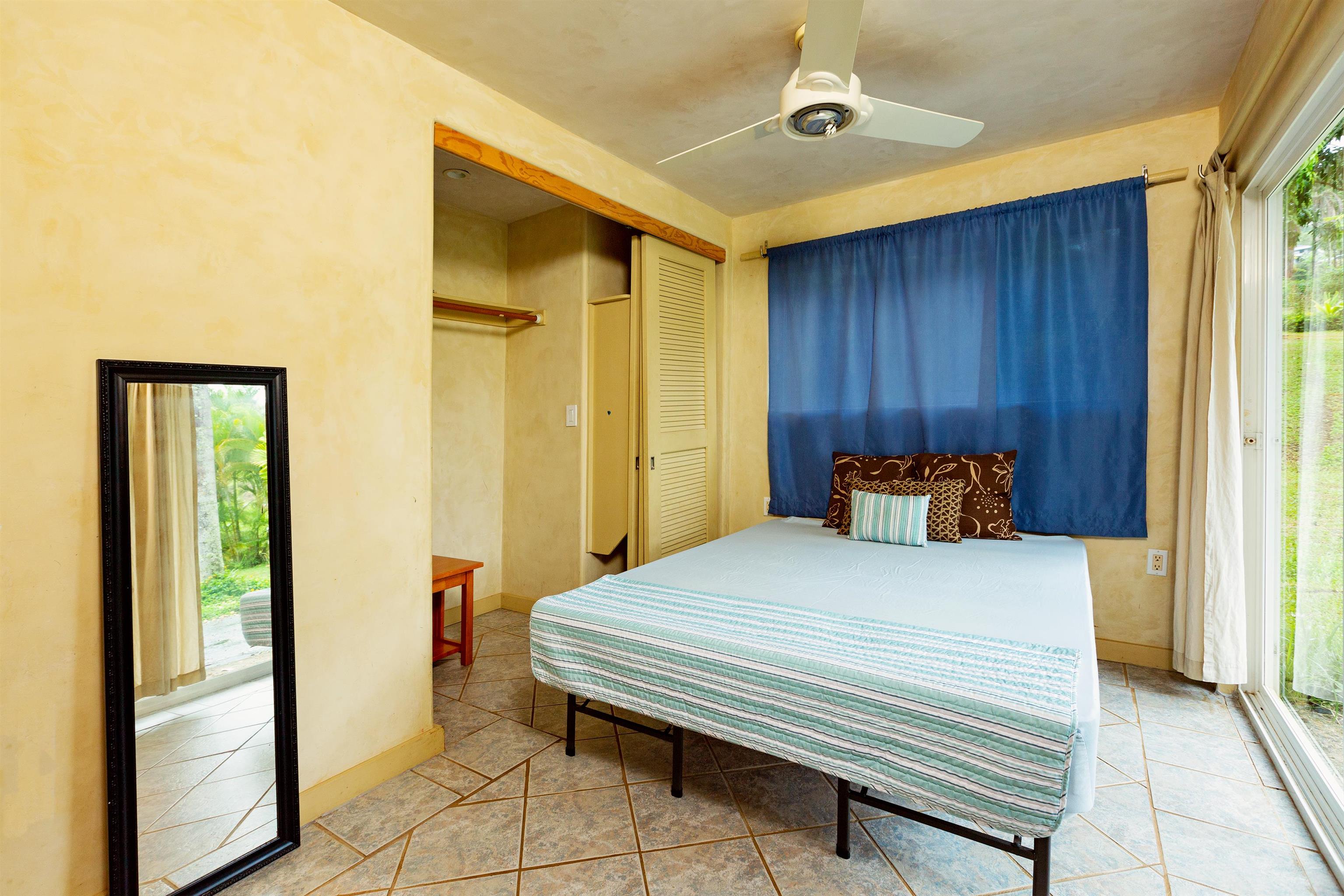 4509 Opana Place Haiku, HI 96708 - Photo 22 of 26 a bedroom with a bed and a walk in closet