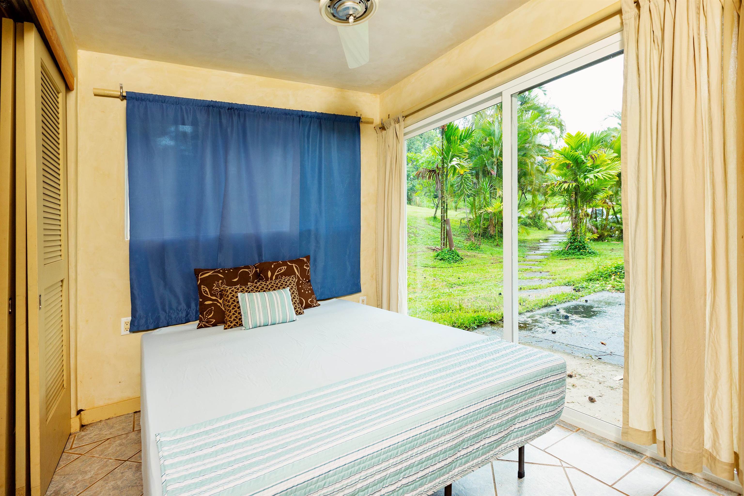 4509 Opana Place Haiku, HI 96708 - Photo 23 of 26 a bedroom with a bed and a window