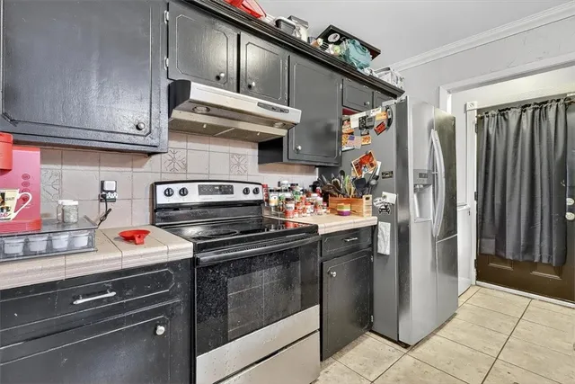 a kitchen with stainless steel appliances granite countertop a stove and a refrigerator