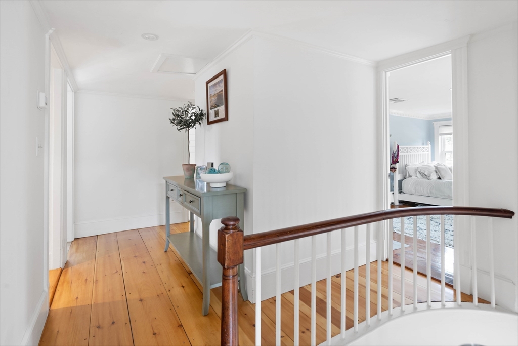 17 Common Street Scituate, MA 02066 - Photo 16 of 39 a view of a hallway with wooden floor and staircase