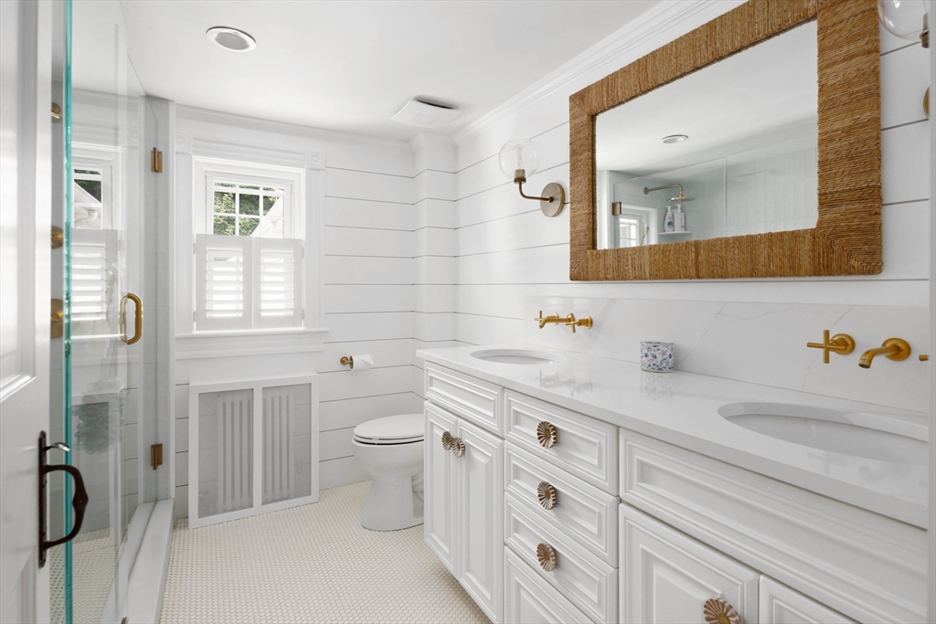 17 Common Street Scituate, MA 02066 - Photo 18 of 39 a bathroom with a granite countertop sink mirror vanity and toilet