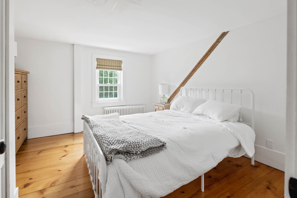 17 Common Street Scituate, MA 02066 - Photo 20 of 39 a bed sitting in a bedroom next to a window