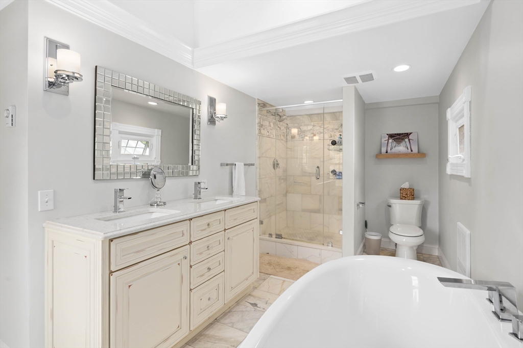 17 Common Street Scituate, MA 02066 - Photo 25 of 39 a bathroom with a double vanity sink mirror double and shower