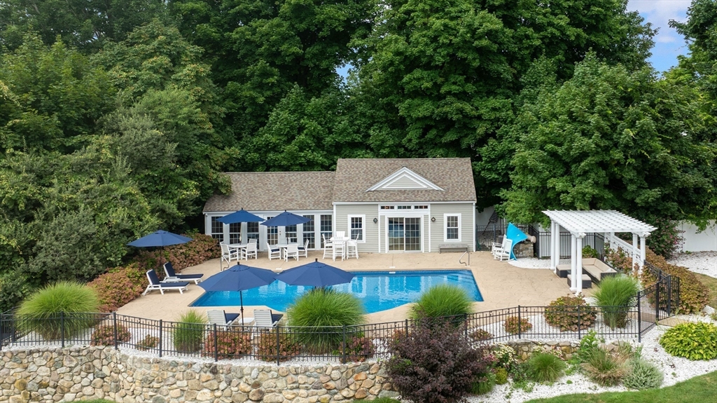 17 Common Street Scituate, MA 02066 - Photo 27 of 39 a front view of a house with a garden and trees