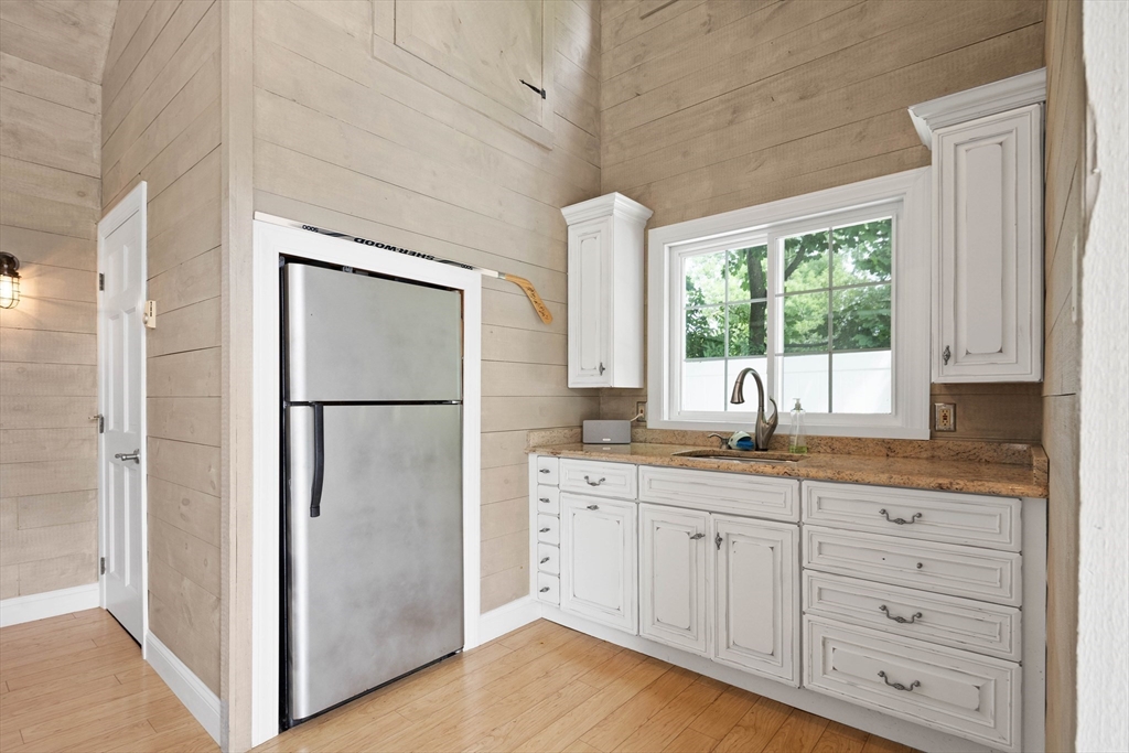 17 Common Street Scituate, MA 02066 - Photo 35 of 39 a kitchen with white cabinets and refrigerator