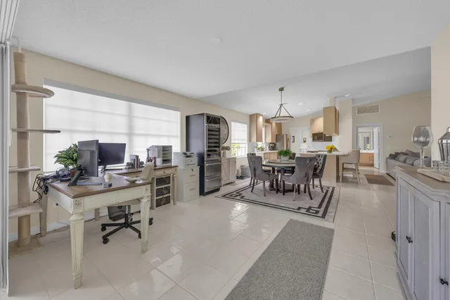 a work room with furniture and a large window