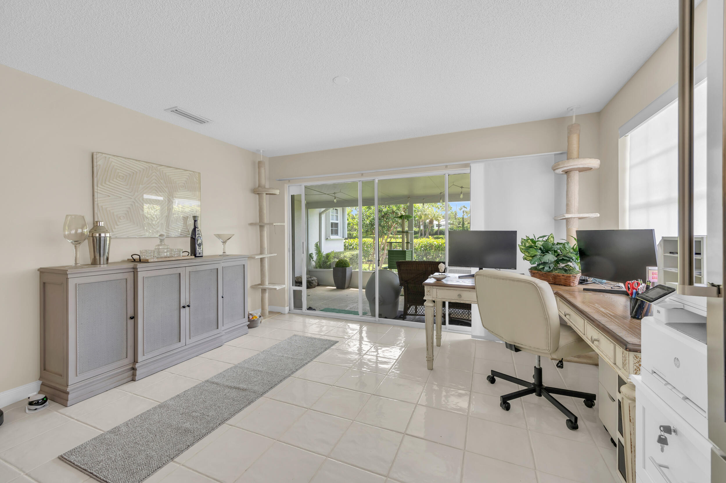 233 Brier Circle Jupiter, FL 33458 - Photo 16 of 31 a living room with furniture a computer on the desk and a window