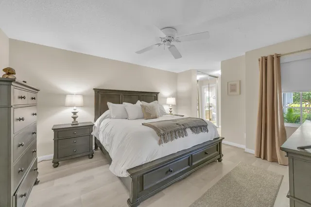 a spacious bedroom with a bed and a dresser